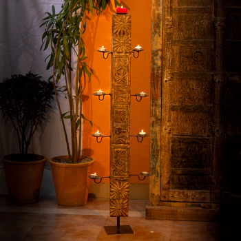 Antique wooden hand-carved candle stand with dark polish and iron base