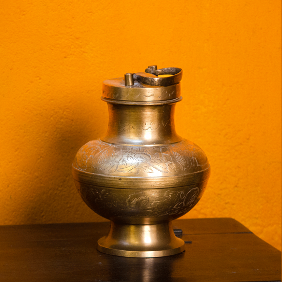 Handcrafted brass Ganga-jal kalash with handle – traditional Indian water pot front view Handcrafted brass Ganga-jal kalash with handle – traditional Indian water pot front view