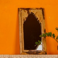 Handcrafted mirror frame made from reclaimed wood with natural textures and a rustic finish.