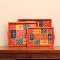 Coral-coloured rectangular tray featuring colourful geometric patterns and traditional floral artwork.