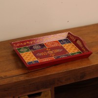 Hand Painted Red Patchwork Tray – Medium Medium wooden serving tray in red, hand painted in a colourful patchwork pattern of floral and geometric motifs in green, blue, and yellow, with cut-out side handles.