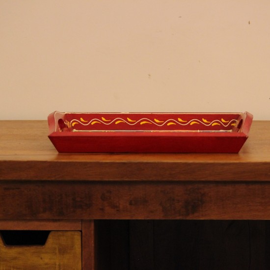 Hand Painted Red Patchwork Tray – Medium Medium wooden serving tray in red, hand painted in a colourful patchwork pattern of floral and geometric motifs in green, blue, and yellow, with cut-out side handles.