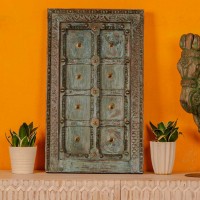 Blue green handcrafted wooden door wall panel with carved detailing and antique metal studs for rustic Indian wall decor