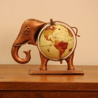 Copper finish elephant globe styled on a wooden desk as statement desk décor