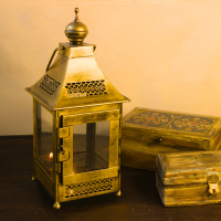 Traditional Indian iron hanging lantern with transparent glass panels and golden polish, ideal for Diwali and spiritual home décor