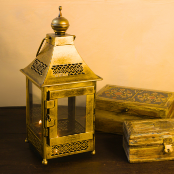 Traditional Indian iron hanging lantern with transparent glass panels and golden polish, ideal for Diwali and spiritual home décor