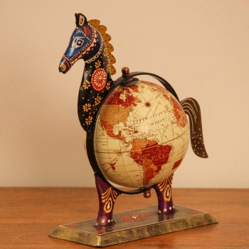 Hand-painted horse globe styled on a wooden desk as colourful desk décor