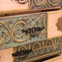 Brass and Natural Wood Wardrobe Cabinet with Carved Drawers 5 ft wooden wardrobe cabinet featuring natural wood finish with intricate brass detailing and multiple carved drawers