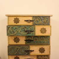 Brass and Natural Wood Wardrobe Cabinet with Carved Drawers 5 ft wooden wardrobe cabinet featuring natural wood finish with intricate brass detailing and multiple carved drawers