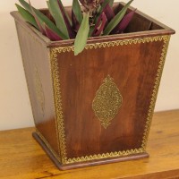 Brown polished wooden planter pot featuring intricate brass embossed border and handcrafted detailing