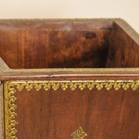 Brown polished wooden planter pot featuring intricate brass embossed border and handcrafted detailing