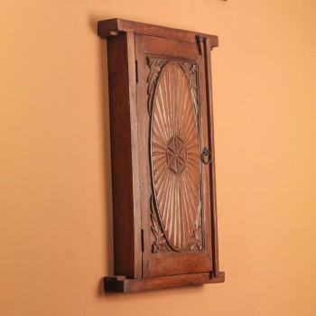 Polished wooden cabinet designed like an old window with carved detailing and antique finish