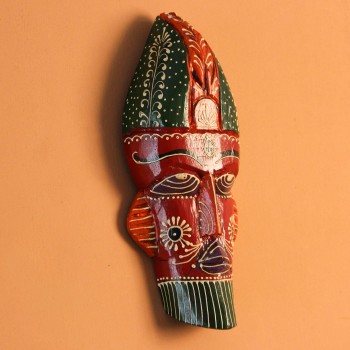 Hand-carved wooden tribal face mask hand painted in red with a green striped crown, purple diamond eyes, and detailed facial motifs in orange and white.