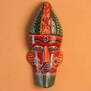 Hand-carved wooden tribal face mask hand painted in red with a green striped crown, purple diamond eyes, and detailed facial motifs in orange and white.