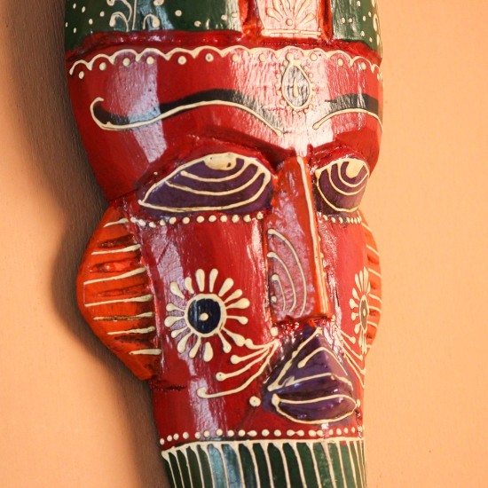 Hand Painted Tribal Face Mask – Red Hand-carved wooden tribal face mask hand painted in red with a green striped crown, purple diamond eyes, and detailed facial motifs in orange and white.