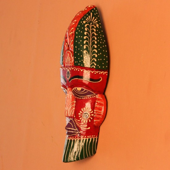 Hand Painted Tribal Face Mask – Red Hand-carved wooden tribal face mask hand painted in red with a green striped crown, purple diamond eyes, and detailed facial motifs in orange and white.