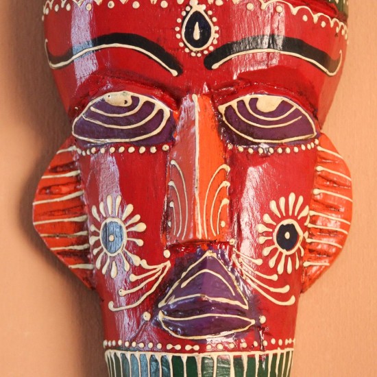 Hand Painted Tribal Face Mask – Red Hand-carved wooden tribal face mask hand painted in red with a green striped crown, purple diamond eyes, and detailed facial motifs in orange and white.
