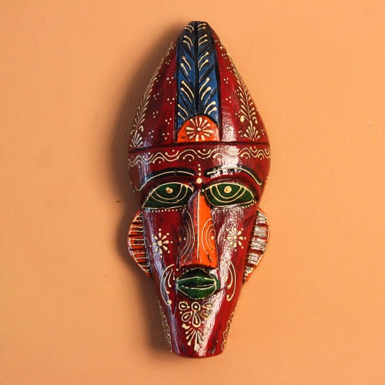 Hand Painted Tribal Face Mask – Maroon Floral Hand-carved wooden tribal face mask hand painted in deep maroon with green eyes and lips, a blue feathered crown, and fine white and orange floral motifs across the face.