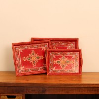 Front view of a set of three hand-painted red wooden serving trays in small, medium and large sizes