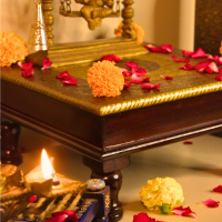 Wooden Square Pooja Chorang Embossed Brass Art 12 x 12 x 6 Inches Wooden square pooja chowki with brass embossing adorned with flowers and diya for festive decor