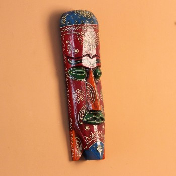 Hand-carved wooden tribal face mask in an elongated form, hand painted in maroon with a mandala-bordered crown, green eyes, and fine white floral detailing.