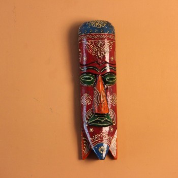 Hand-carved wooden tribal face mask in an elongated form, hand painted in maroon with a mandala-bordered crown, green eyes, and fine white floral detailing.