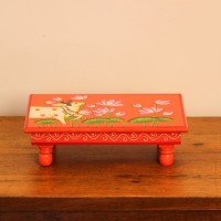 Hand Painted Cow & Lotus Chowki – Large Large wooden chowki hand painted in Pichwai style, featuring a cow standing amid blooming pink lotus flowers on a vivid red base, edged with a plain wooden border.