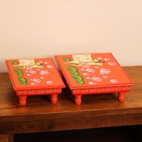 Hand Painted Cow & Lotus Chowki – Large Large wooden chowki hand painted in Pichwai style, featuring a cow standing amid blooming pink lotus flowers on a vivid red base, edged with a plain wooden border.