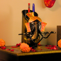 Handcrafted Ganesha Pen Stand and Flower Vase – Festive Desk Decor by Indune Handcrafted Ganesha metal pen stand styled with marigold flowers and festive pooja decor