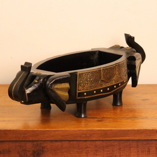 Dark Wooden Decorative Bowl Dark wooden oval bowl featuring sculpted animal-shaped ends and an ornate gold-patterned side panel.
