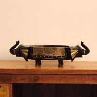 Dark Wooden Decorative Bowl Dark wooden oval bowl featuring sculpted animal-shaped ends and an ornate gold-patterned side panel.