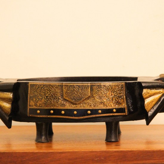 Dark Wooden Decorative Bowl Dark wooden oval bowl featuring sculpted animal-shaped ends and an ornate gold-patterned side panel.