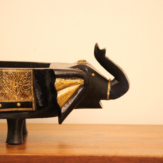 Dark Wooden Decorative Bowl Dark wooden oval bowl featuring sculpted animal-shaped ends and an ornate gold-patterned side panel.