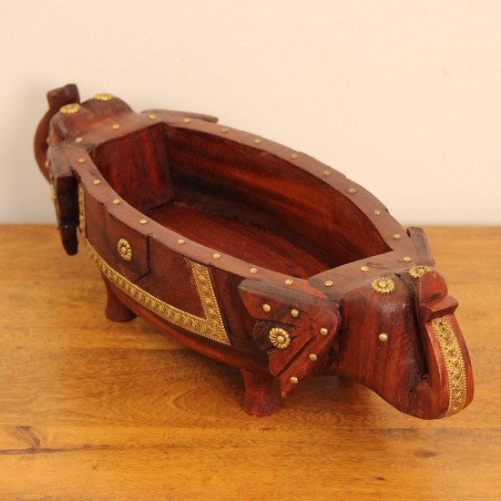 Two Elephant Head Fruit Bowl Styled on Table Brown polish wooden elephant head fruit bowl with brass detailing placed on a wooden table as a dining or console centrepiece.