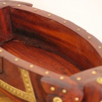 Two Elephant Head Fruit Bowl Styled on Table Brown polish wooden elephant head fruit bowl with brass detailing placed on a wooden table as a dining or console centrepiece.
