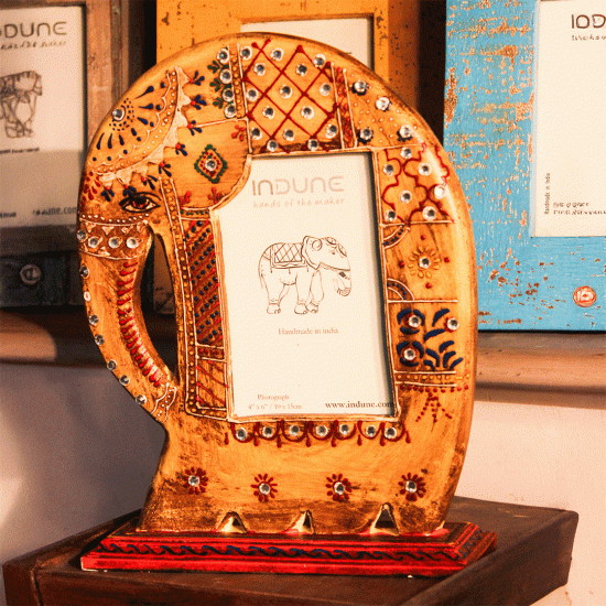 Hand-painted wooden elephant photo frame with stand in yellow orange finish Hand-painted wooden elephant photo frame with stand in yellow orange finish