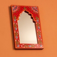 Jharokha Mirror Frame – Hand Painted Red Hand-carved wooden mirror frame in a jharokha arch shape, hand painted in red with a fine floral border in blue, green, and white, framing an arched mirror at the centre.