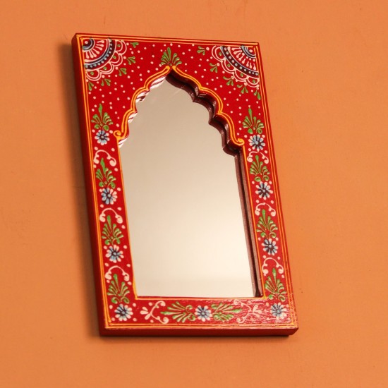 Jharokha Mirror Frame – Hand Painted Red Hand-carved wooden mirror frame in a jharokha arch shape, hand painted in red with a fine floral border in blue, green, and white, framing an arched mirror at the centre.