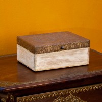 Distressed white wooden box with brass embossed top
