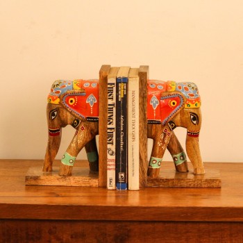 Hand Painted Wooden Elephant Bookends A pair of wooden elephant-shaped bookends, hand painted in red, blue, and yellow folk-art patterns, mounted on flat wooden bases to hold books upright.