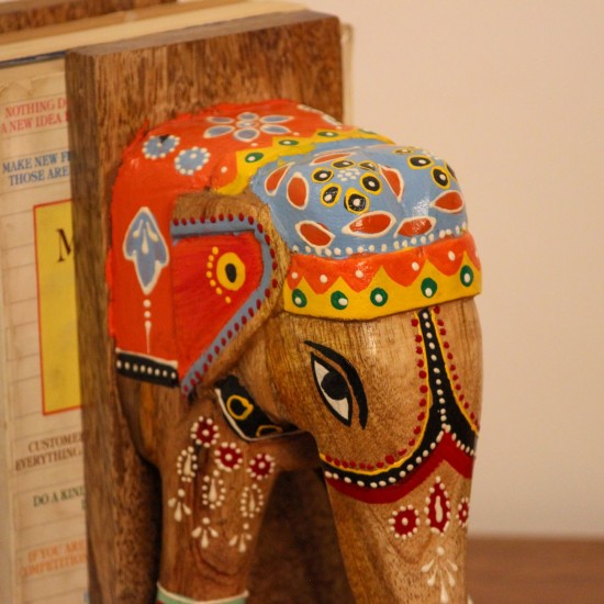Hand Painted Wooden Elephant Bookends A pair of wooden elephant-shaped bookends, hand painted in red, blue, and yellow folk-art patterns, mounted on flat wooden bases to hold books upright.
