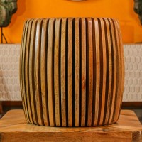 Handcrafted spiral slatted wooden stool with natural wood finish used as side table or accent stool