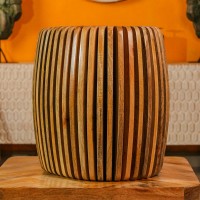 Handcrafted spiral slatted wooden stool with natural wood finish used as side table or accent stool