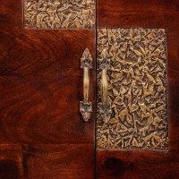 Premium dark wood two door cabinet with decorative embossed brass panels on the front