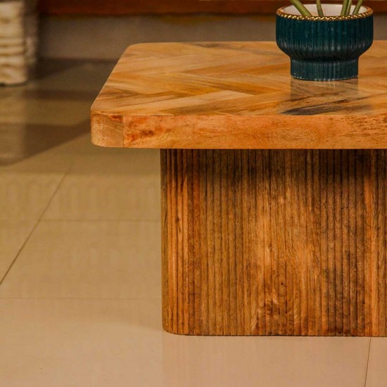 Wooden coffee table with chevron pattern tabletop and natural wood finish