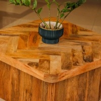 Wooden coffee table with chevron pattern tabletop and natural wood finish