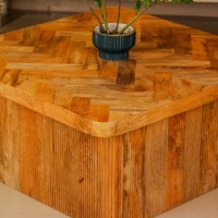 Large wooden coffee table with chevron pattern top and natural wood finish