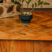 Large wooden coffee table with chevron pattern top and natural wood finish