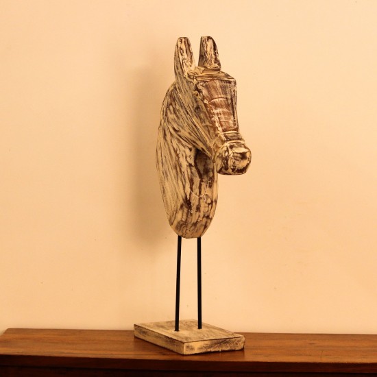 Hand-carved wooden horse head in a distressed whitewash finish, with a flowing textured mane, mounted on a slender black iron stand as a standalone decorative accent.
