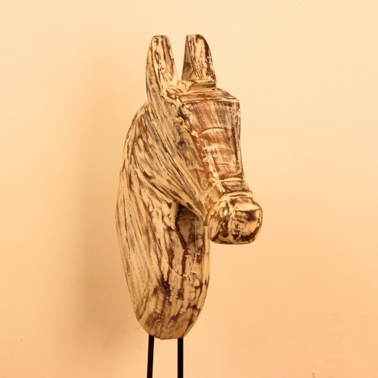 Hand-carved wooden horse head in a distressed whitewash finish, with a flowing textured mane, mounted on a slender black iron stand as a standalone decorative accent.